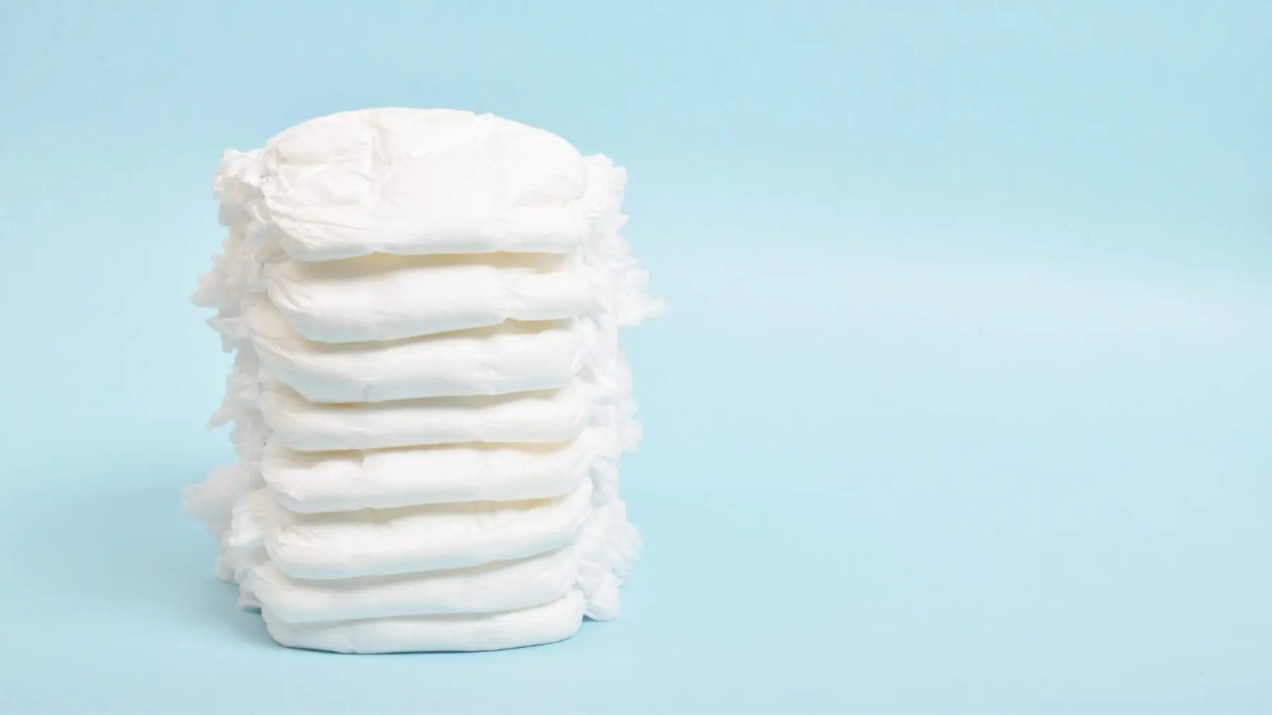 Stack of diapers on a blue background.