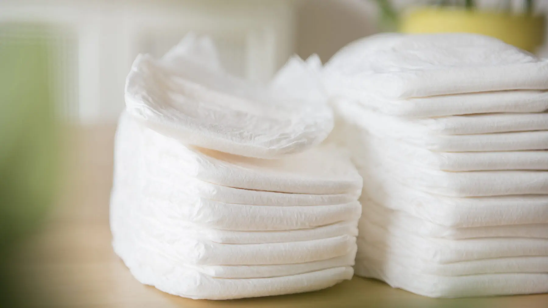 Stack of diapers on blurred background.
