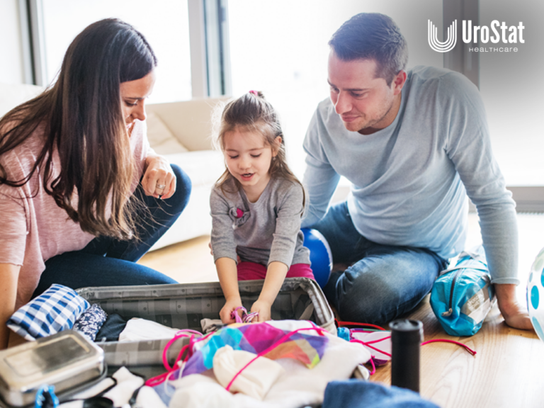 Mom, dad, and daughter packing her stuff on the floor together