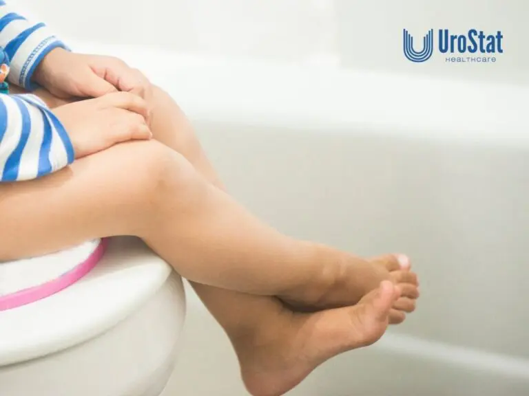 Child sitting on a potty training seat on a toilet.