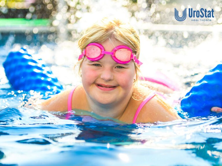 Young girl with special needs in the pool with a blue float and pink goggles