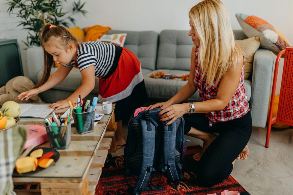 Mother and her daughter with Down’s syndrome preparing for school