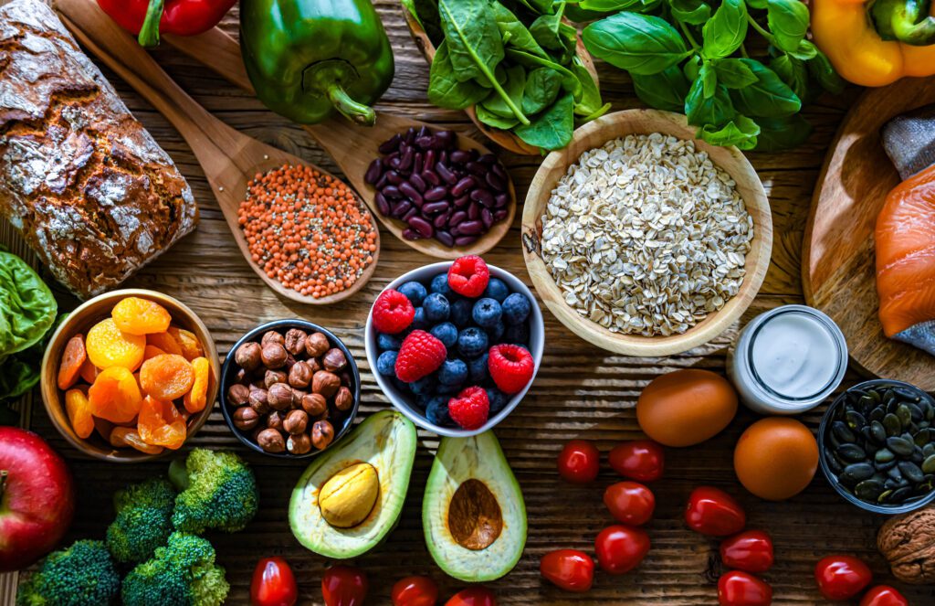 Assortment of food items such as fruits, vegetables, breads, beans, and more