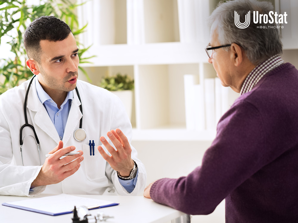 Male doctor speaking to male patient about catheter