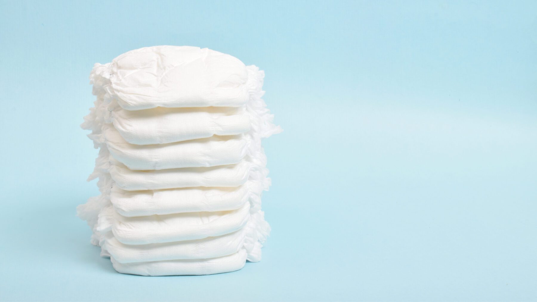 Stack of diapers on a blue background.