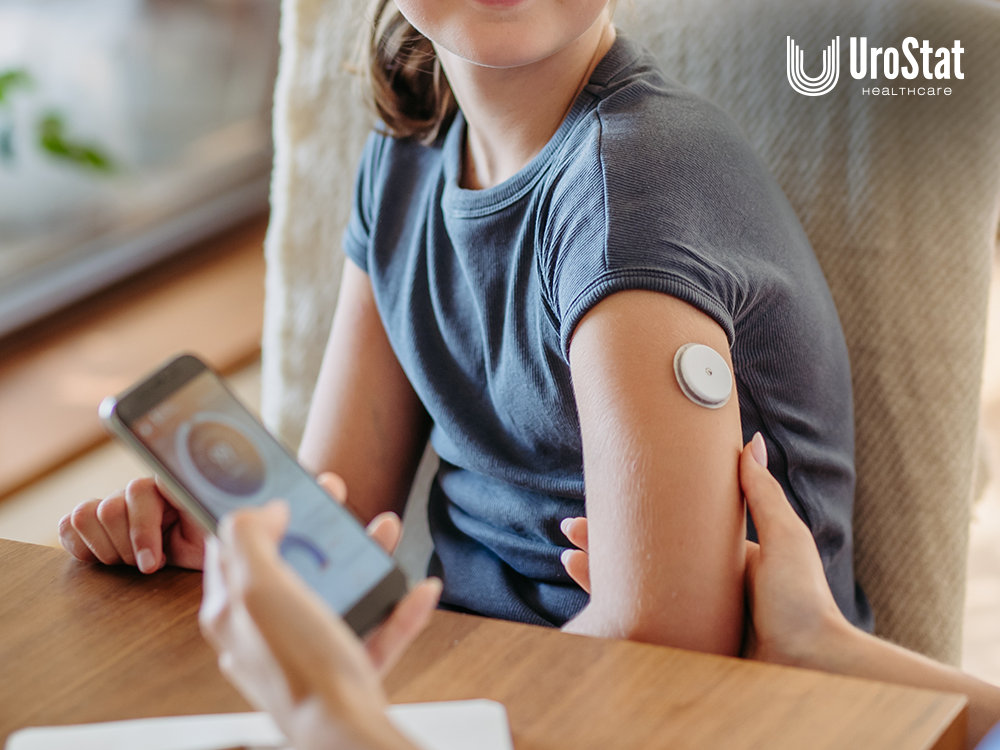 Parent holding smartphone in one hand with monitoring app and child's arm in the other that has a continuous glucose sensor on it