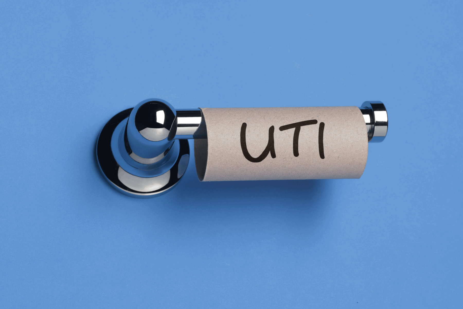 Empty toilet roll on holder that says UTI