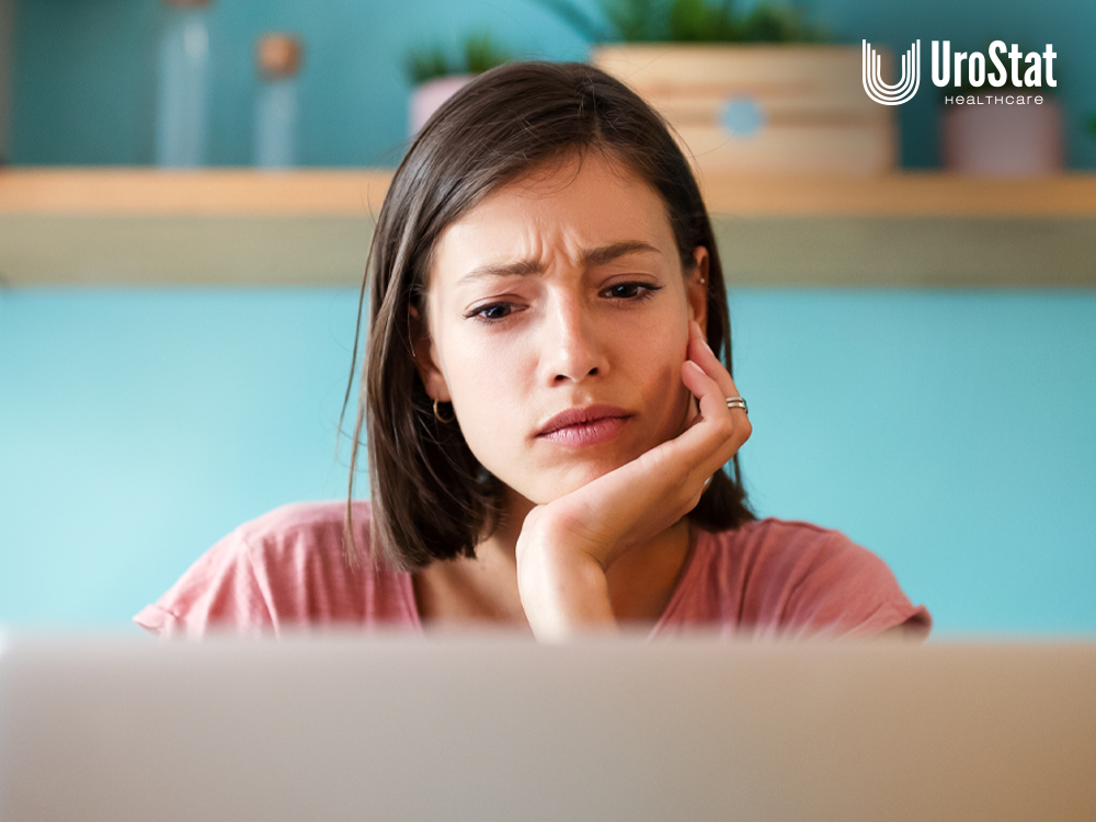 Mom looking at laptop in concern with her hand on her chin