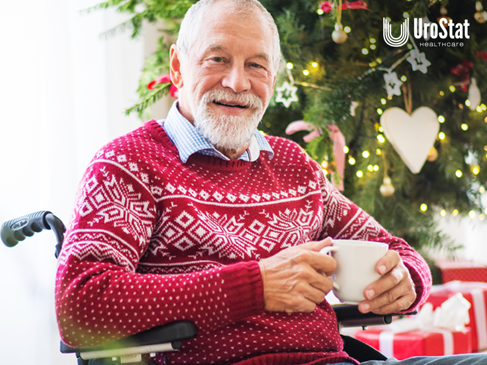 Older man in holiday sweater in a wheelchair, drinking coffee during holiday season