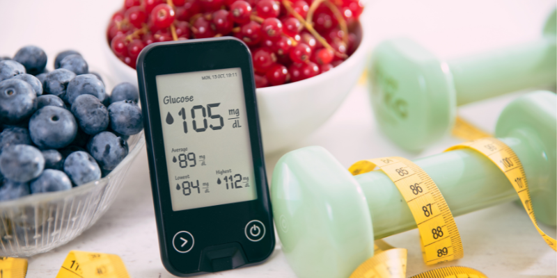 Glucose reader, weights, measuring tape, and blueberries