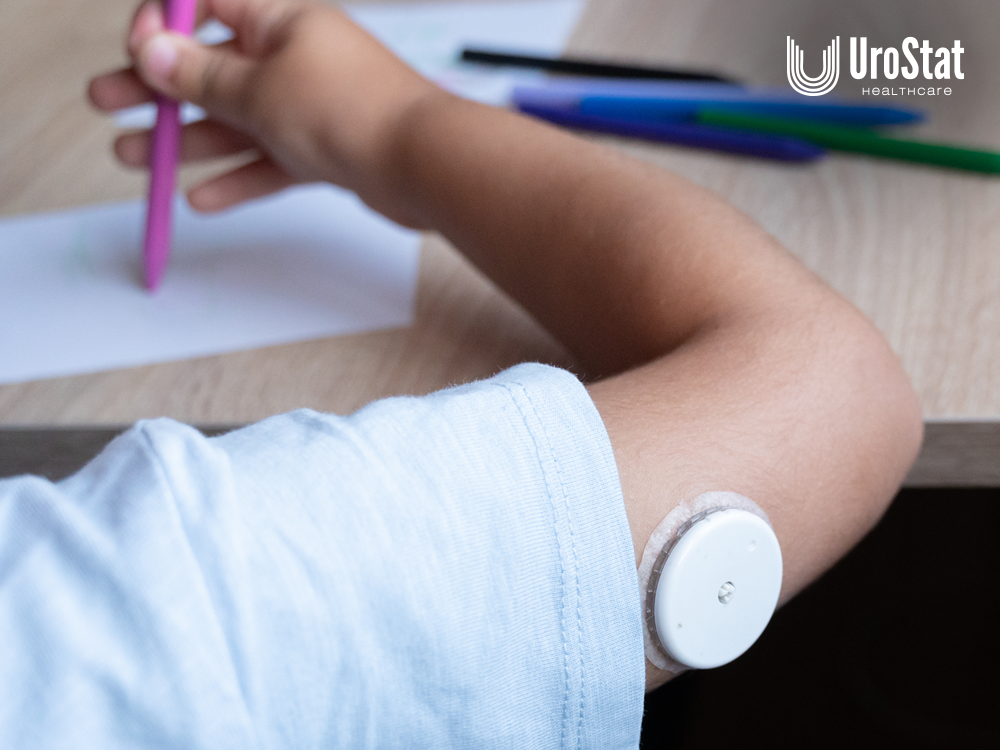 Child with CGM on the back of their arm