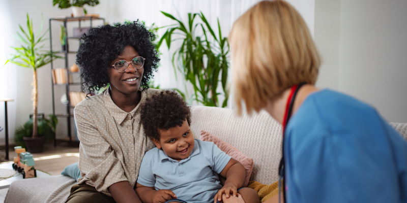 Mother with son and healthcare professional