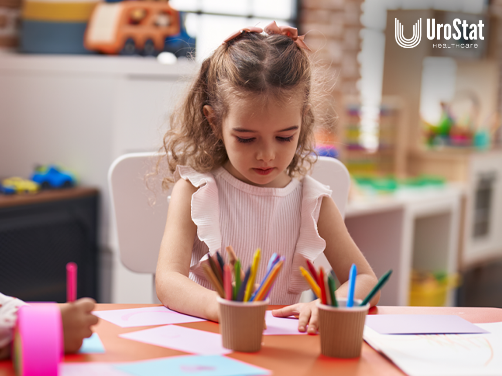 Child sitting at table and using pencils